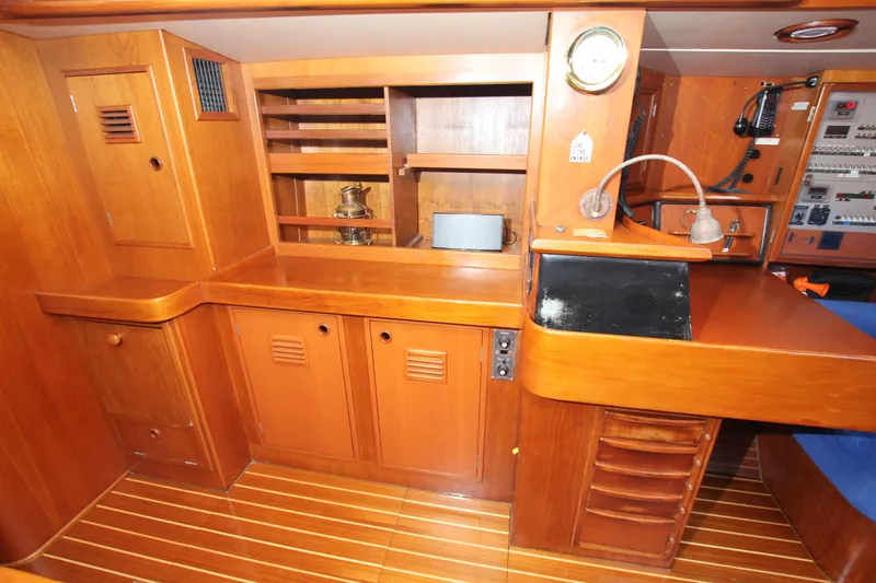 Slide: The Image of Interior of 1989 Nautor Swan 53 yacht with wooden cabinetry and navigation station. - 32