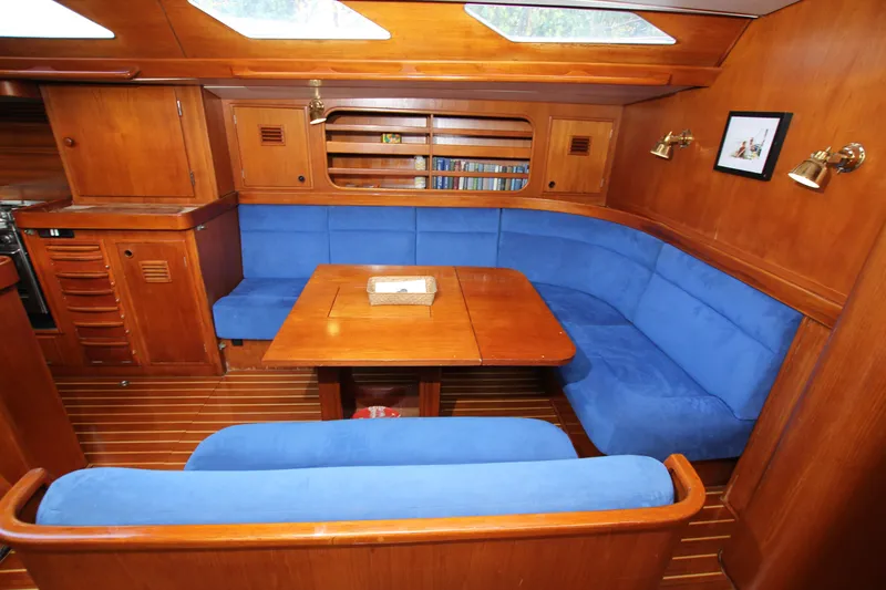 Slide: The Image of Interior of 1989 Nautor Swan 53 yacht with blue seating and wooden finishes. - 33