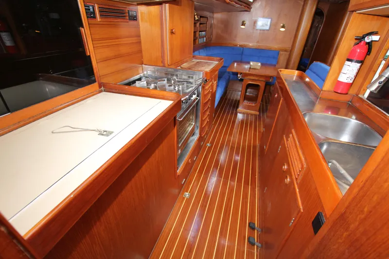 Slide: The Image of Interior of 1989 Nautor Swan 53 yacht with wooden cabinetry and blue seating. - 37