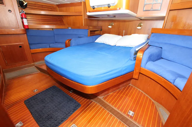 Slide: The Image of Luxurious cabin interior of 1989 Nautor Swan 53 yacht with blue bedding and wooden finish. - 38