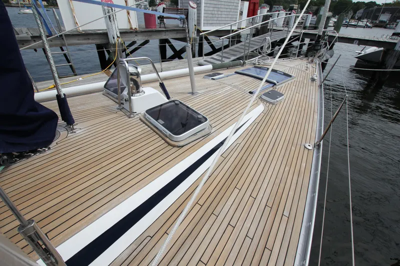 Slide: The Image of Deck of 1989 Nautor Swan 53 yacht with teak finish, docked at marina. - 4