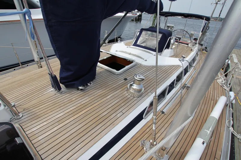 Slide: The Image of 1989 Nautor Swan 53 sailboat with teak deck, docked at marina. - 6