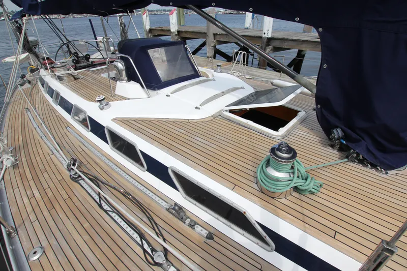 Slide: The Image of 1989 Nautor Swan 53 yacht with teak deck and open hatch at dock. - 7