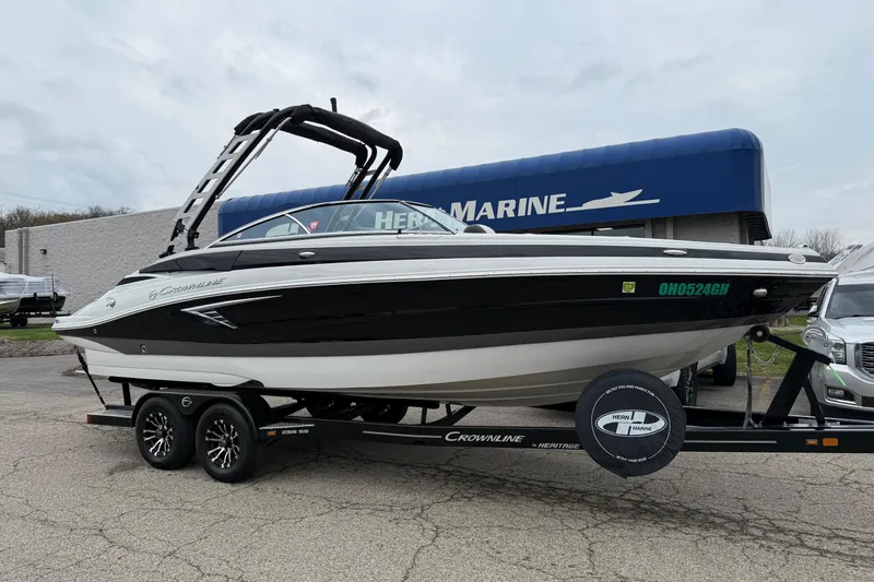 The Image of 2022 Crownline 255 SS boat on trailer at marine dealership. - 0
