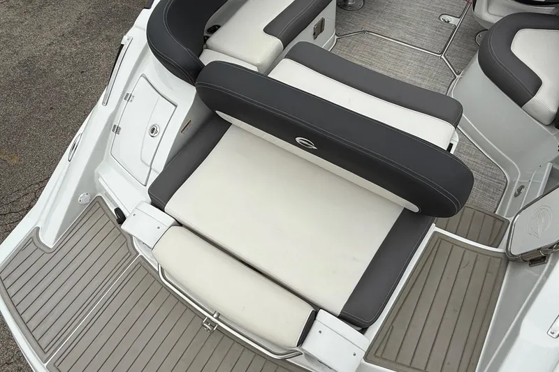 Slide: The Image of 2022 Crownline 255 SS boat interior with cushioned seating and deck flooring. - 14