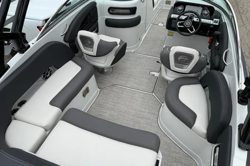 Slide: The Image of 2022 Crownline 255 SS boat interior with gray and white seating, modern dashboard, and carpeted flooring. - 5
