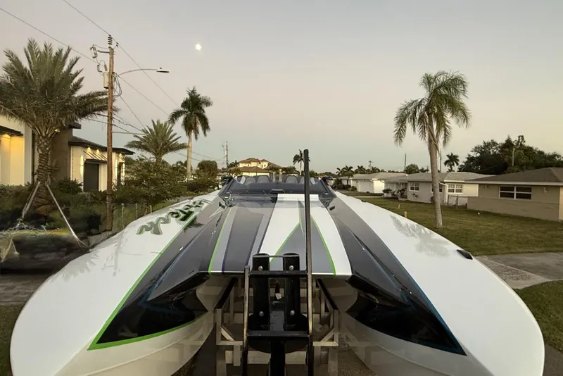 Slide: The Image of 2025 Nor-Tech 4000 Roadster on trailer, viewed from rear, under a partly cloudy sky. - 5