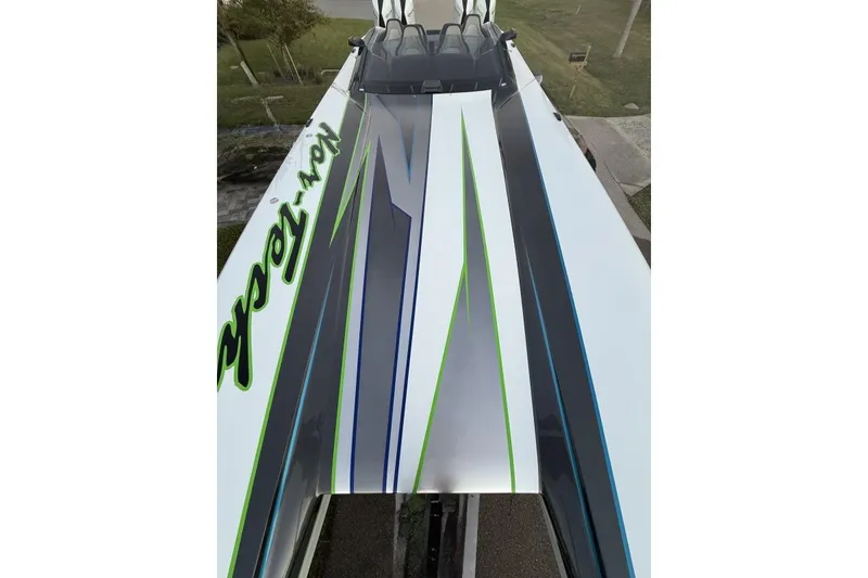 Slide: The Image of Underneath view of a 2025 Nor-Tech 4000 Roadster on a trailer with a spare tire. - 7