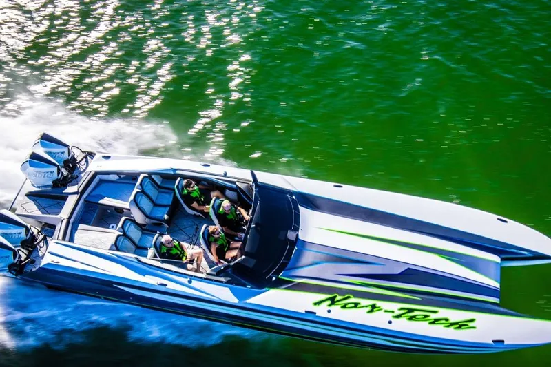 The Image of 2026 Nor-Tech 4000 Roadster speedboat cruising on vibrant green water. - 0
