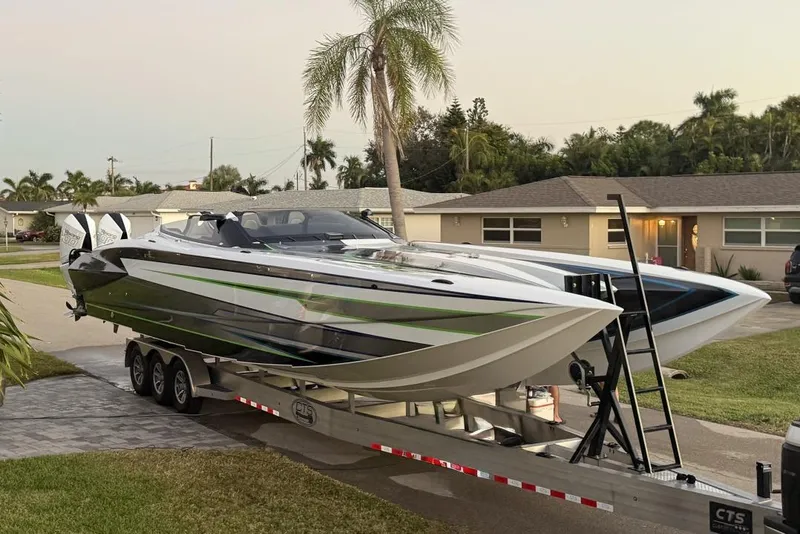 Slide: The Image of 2026 Nor-Tech 4000 Roadster boat on trailer in suburban neighborhood driveway. - 2