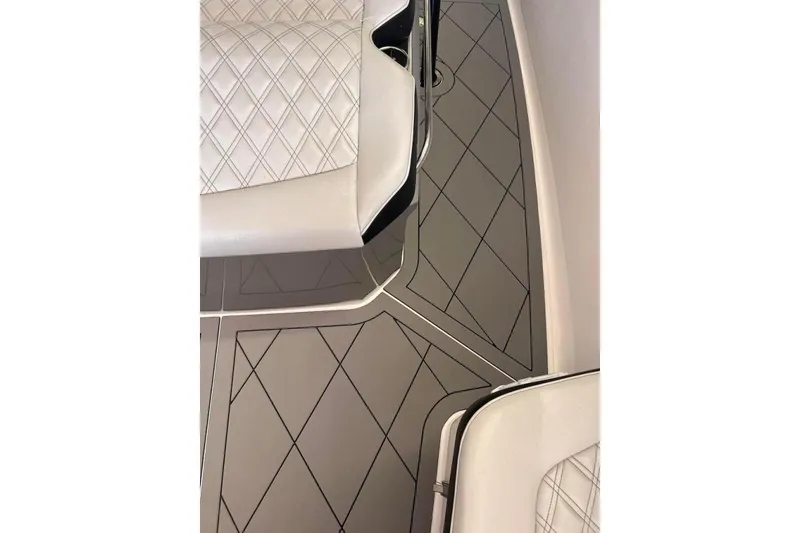 Slide: The Image of 2017 Nor-Tech 340 Sport Center Console interior with diamond-stitched seats and patterned flooring. - 15