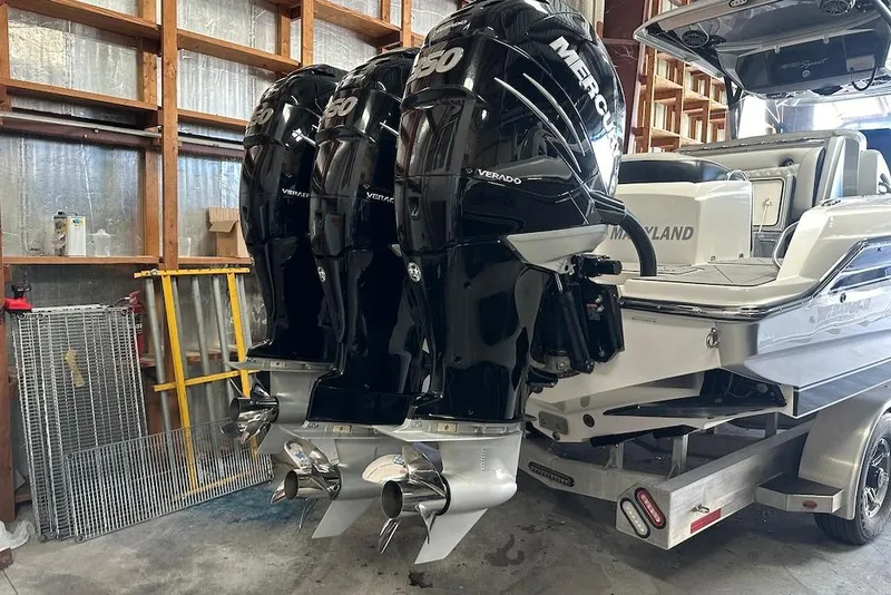 Slide: The Image of 2017 Nor-Tech 340 Sport Center Console with triple Mercury Verado engines in a garage. - 20