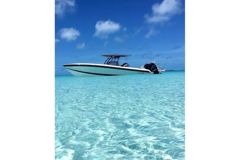 Slide: The Image of 2017 Nor-Tech 340 Sport Center Console in clear turquoise waters under blue sky. - 3