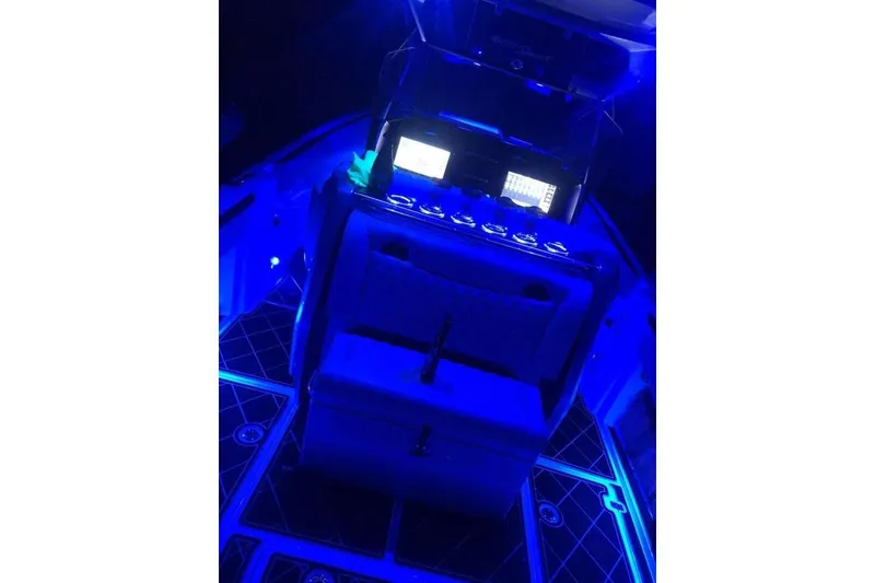 Slide: The Image of 2017 Nor-Tech 340 Sport Center Console with illuminated blue cockpit at night. - 9
