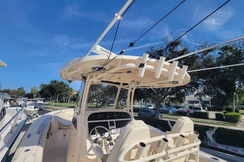 Slide: The Image of 2019 Grady-White Canyon 306 boat with Garmin equipment, docked under clear blue sky. - 12