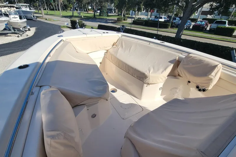Slide: The Image of 2019 Grady-White Canyon 306 boat interior with beige seating and covers. - 18