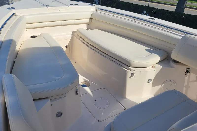 Slide: The Image of 2019 Grady-White Canyon 306 boat interior with cushioned seating and storage compartments. - 19