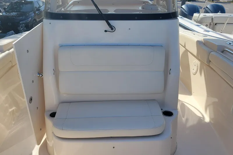 Slide: The Image of 2019 Grady-White Canyon 306 boat interior with cushioned seating and cup holders. - 20