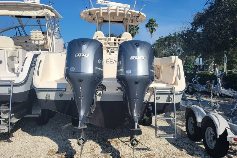 Slide: The Image of 2019 Grady-White Canyon 306 boat with twin Yamaha 300 engines, parked outdoors. - 3