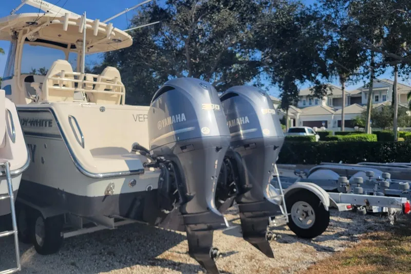 Slide: The Image of 2019 Grady-White Canyon 306 boat with dual Yamaha outboard engines, parked on a trailer. - 4