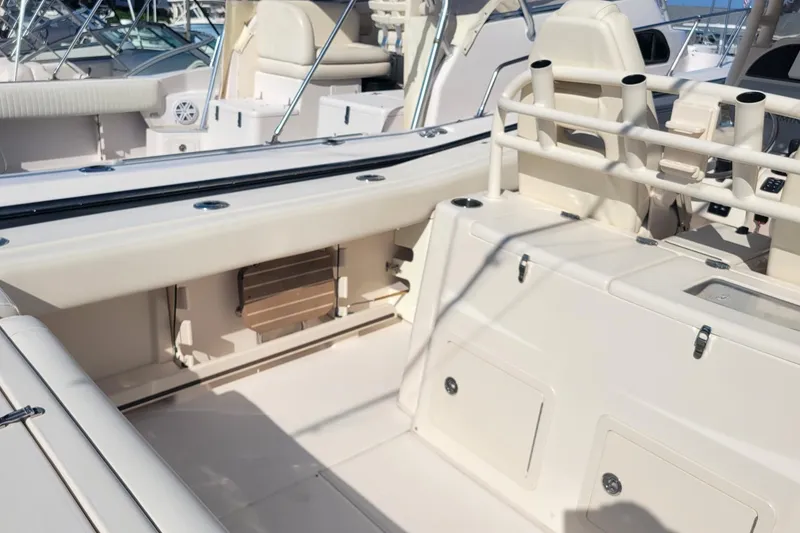 Slide: The Image of 2019 Grady-White Canyon 306 boat interior with seating and rod holders. - 7