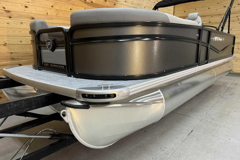 Slide: The Image of 2025 Premier Sunscape 220 RL pontoon boat in showroom, side view. - 4