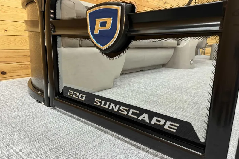 Slide: The Image of 2025 Premier Sunscape 220 RL boat interior with logo and seating detail. - 5