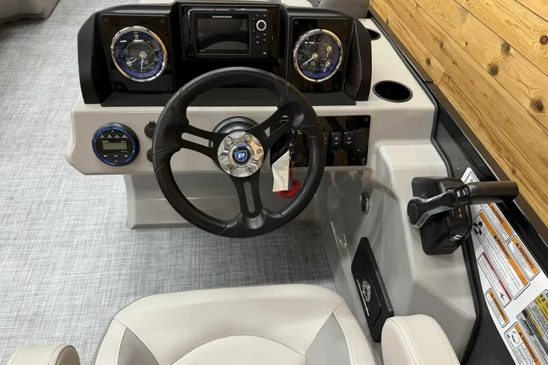 Slide: The Image of 2025 Premier Sunscape 220 RL boat dashboard with steering wheel and control panel. - 8