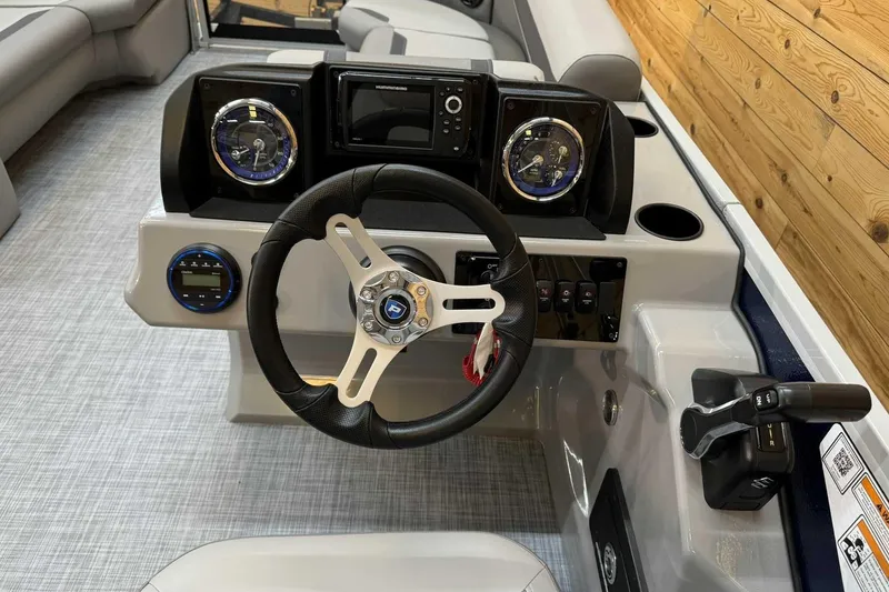 Slide: The Image of 2025 Premier Sunscape 220 RF XLC boat dashboard with steering wheel and controls. - 11