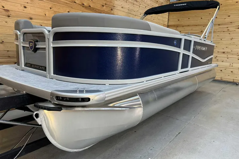 Slide: The Image of 2025 Premier Sunscape 220 RF XLC pontoon boat in showroom, featuring sleek design and modern finishes. - 4