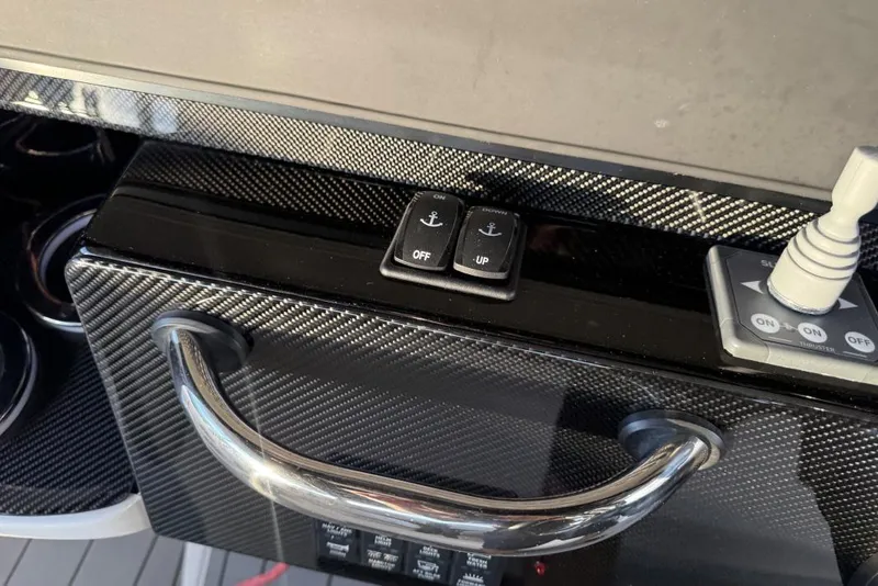Slide: The Image of Control panel of 2025 Nor-Tech 390 Sport Center Console with carbon fiber finish. - 11