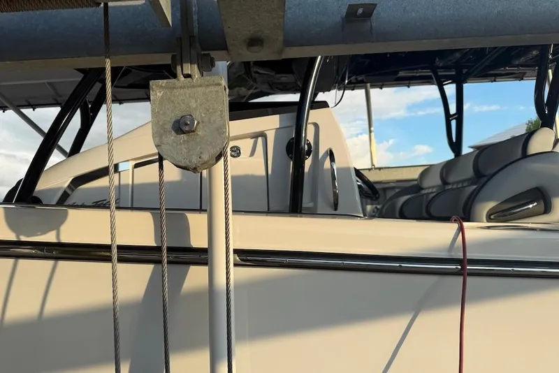 Slide: The Image of 2025 Nor-Tech 390 Sport Center Console boat interior with seating and control panel. - 12