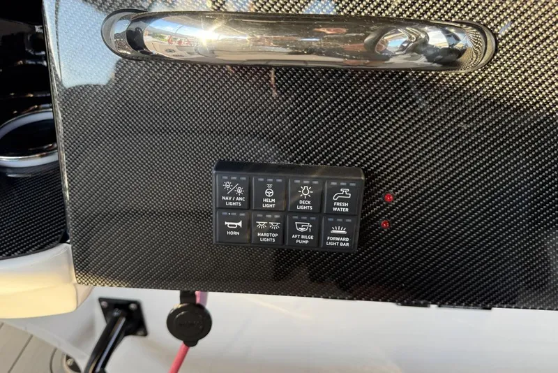 Slide: The Image of Control panel on 2025 Nor-Tech 390 Sport Center Console with carbon fiber finish. - 13