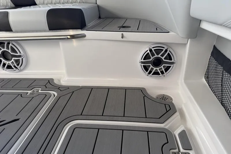 Slide: The Image of 2025 Nor-Tech 390 Sport Center Console interior with speakers and cushioned seating. - 15