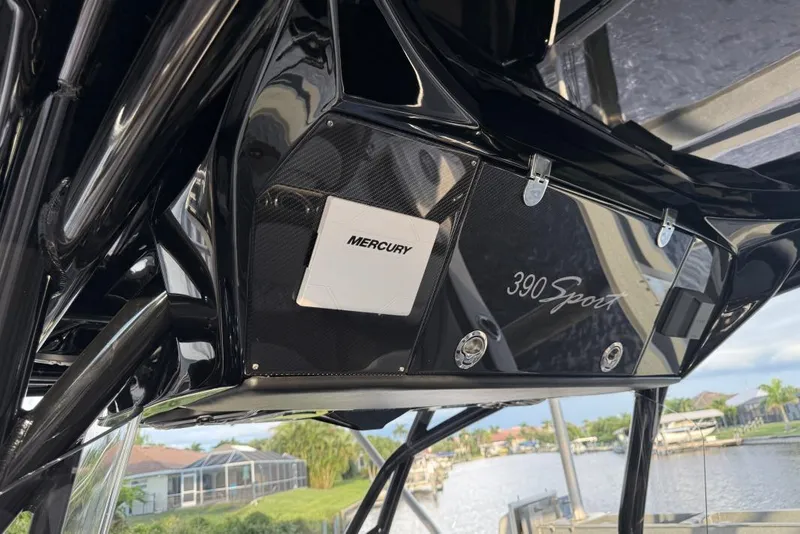 Slide: The Image of 2025 Nor-Tech 390 Sport Center Console with Mercury engine, sleek black design. - 16