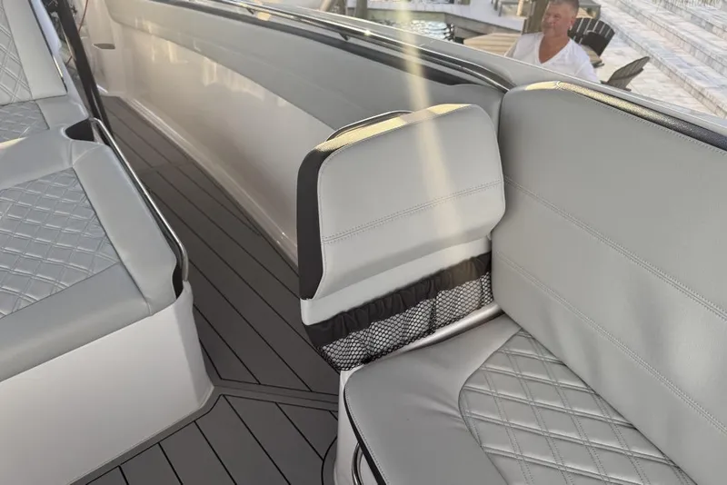 Slide: The Image of 2025 Nor-Tech 390 Sport Center Console interior with gray quilted seating and sleek design. - 17