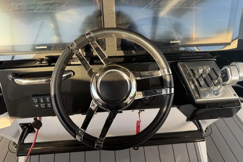 Slide: The Image of Steering wheel and controls of 2025 Nor-Tech 390 Sport Center Console boat. - 20