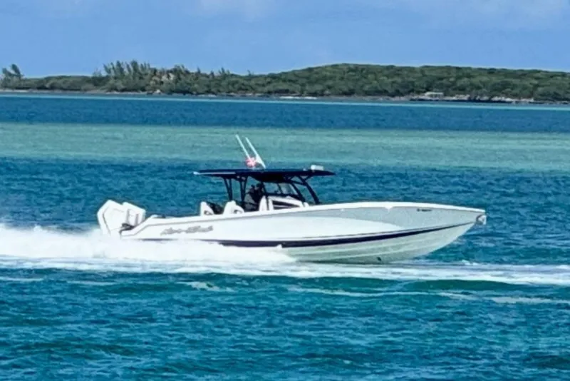 Slide: The Image of 2025 Nor-Tech 390 Sport Center Console cruising on turquoise waters. - 23