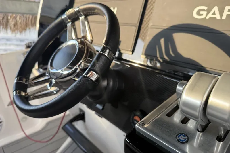 Slide: The Image of 2025 Nor-Tech 390 Sport Center Console steering wheel and controls, featuring Garmin technology. - 6