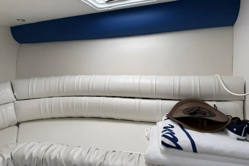 Slide: The Image of Interior of 1999 Hustler 388 SLINGSHOT boat with white leather seating and accessories. - 6