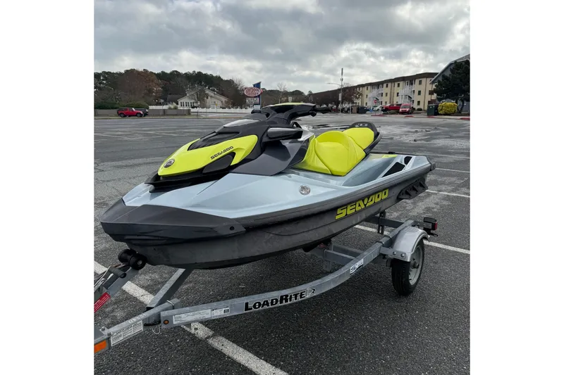 Slide: The Image of 2021 Sea-Doo GTI SE 130 jet ski on trailer in parking lot. - 16