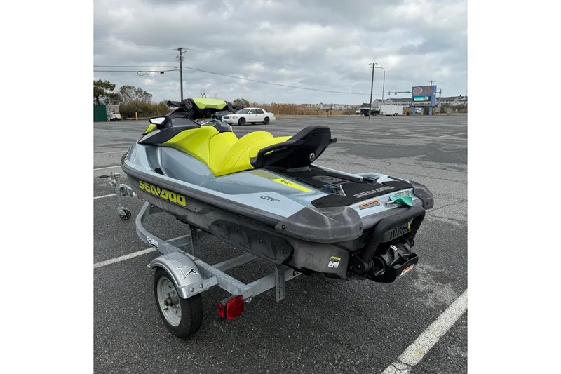 Slide: The Image of 2021 Sea-Doo GTI SE 130 jet ski on trailer in parking lot. - 18
