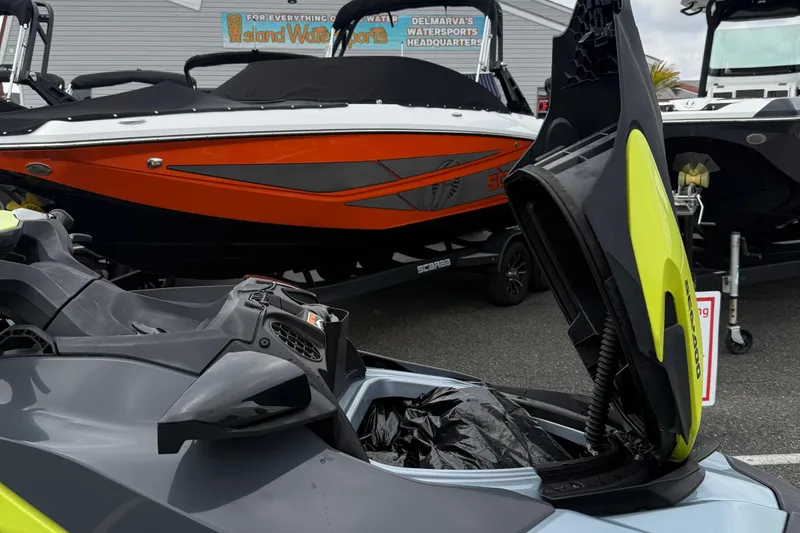 Slide: The Image of 2021 Sea-Doo GTI SE 130 with open storage compartment, displayed at a watersports dealership. - 21