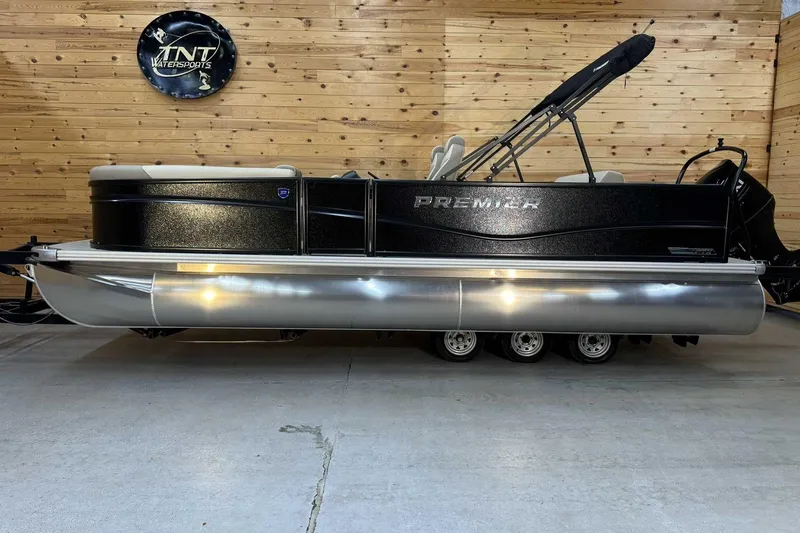 The Image of 2025 Premier Sunscape 220 RL pontoon boat in showroom, wooden wall background. - 1