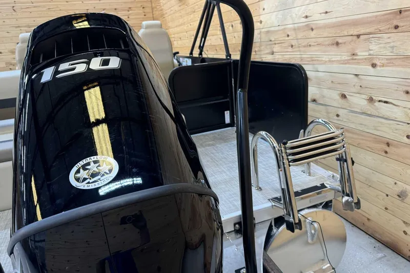 Slide: The Image of 2025 Premier Sunscape 220 RL boat with 150 HP engine and ladder in wooden interior. - 3
