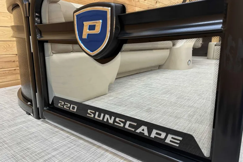 Slide: The Image of 2025 Premier Sunscape 220 RL boat interior with logo and seating detail. - 5