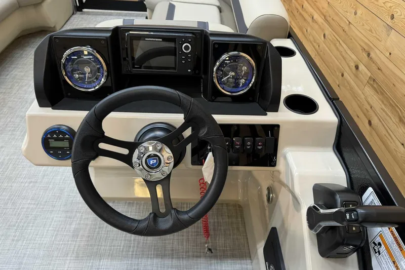 Slide: The Image of 2025 Premier Sunscape 220 RL boat dashboard with steering wheel and control panel. - 8