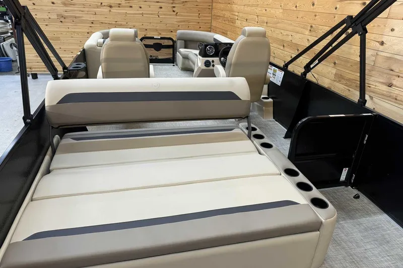 Slide: The Image of 2025 Premier Sunscape 220 RL boat interior with beige seating and wooden paneling. - 9