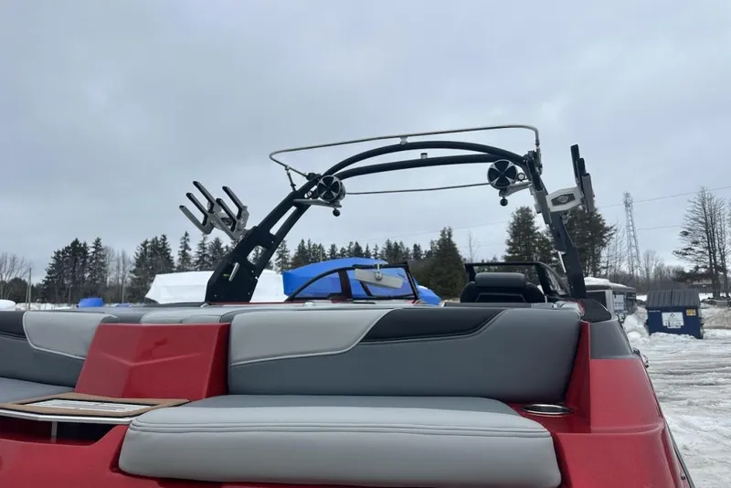 Slide: The Image of 2019 Malibu Wakesetter 23 LSV boat with red and gray seating, winter setting. - 10