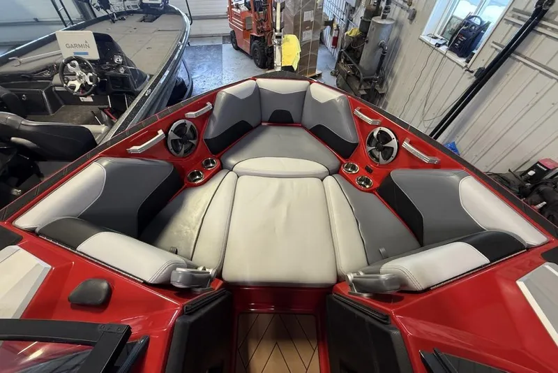Slide: The Image of 2019 Malibu Wakesetter 23 LSV interior with red and gray seating in a garage. - 13